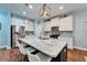 Gourmet kitchen boasts a large island with seating, pendant lights, and stainless appliances at 7510 Lantern Park Ave, Apollo Beach, FL 33572