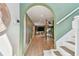 Hallway with arched opening, hardwood floors, and views to an entertainment area at 7551 141St St, Seminole, FL 33776