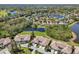 Beautiful aerial view of the community featuring lakefront property and well-maintained landscaping at 767 Tremont Greens Ln # 64, Sun City Center, FL 33573