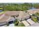 Aerial view of the home showcasing landscaping, driveway, and proximity to natural surroundings at 767 Tremont Greens Ln # 64, Sun City Center, FL 33573