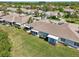 Scenic aerial view of tan roofed homes and landscaped yards in this lakeside community at 767 Tremont Greens Ln # 64, Sun City Center, FL 33573