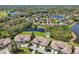 Beautiful aerial view of the community featuring lakefront property and well-maintained landscaping at 767 Tremont Greens Ln # 64, Sun City Center, FL 33573
