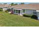 A backyard featuring a lawn, patio, and screened-in lanai at 767 Tremont Greens Ln # 64, Sun City Center, FL 33573