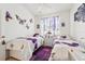 Bright bedroom with butterfly accents, twin beds, and natural light at 767 Tremont Greens Ln # 64, Sun City Center, FL 33573
