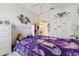 Bright bedroom featuring a decorative purple butterfly theme and white furnishings at 767 Tremont Greens Ln # 64, Sun City Center, FL 33573