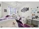 Bright bedroom with twin beds, butterfly decor, and workspace at 767 Tremont Greens Ln # 64, Sun City Center, FL 33573