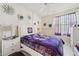 Cozy bedroom featuring a stylish bed, soft lighting, and decorative wall art for a comfortable retreat at 767 Tremont Greens Ln # 64, Sun City Center, FL 33573