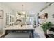 Bright dining room features stylish marble table, decorative chandelier, and seamless flow into other living spaces at 767 Tremont Greens Ln # 64, Sun City Center, FL 33573
