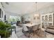 Open-concept dining area adjacent to the living room, featuring elegant lighting and modern furnishings at 767 Tremont Greens Ln # 64, Sun City Center, FL 33573