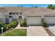 Charming condo with manicured lawn, metal gate, and two car garage at 767 Tremont Greens Ln # 64, Sun City Center, FL 33573
