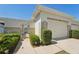 Charming front exterior with a private walkway leading to the entrance and a one-car garage at 767 Tremont Greens Ln # 64, Sun City Center, FL 33573