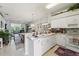 Open kitchen featuring a breakfast bar that seamlessly connects to a sunny living area, perfect for entertaining at 767 Tremont Greens Ln # 64, Sun City Center, FL 33573