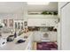 Well-lit kitchen with white cabinetry, practical appliances, and a breakfast bar for casual dining at 767 Tremont Greens Ln # 64, Sun City Center, FL 33573