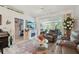 Bright living room with a fireplace, comfortable seating, and access to a screened lanai at 767 Tremont Greens Ln # 64, Sun City Center, FL 33573