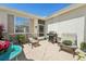 Private patio with comfortable seating, a grill, and a view of the surrounding landscape at 767 Tremont Greens Ln # 64, Sun City Center, FL 33573