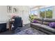Sunroom showcasing a comfortable seating area, workspace, and abundant natural light at 767 Tremont Greens Ln # 64, Sun City Center, FL 33573