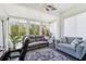 Inviting sunroom featuring comfortable seating, neutral color palette and lots of windows at 767 Tremont Greens Ln # 64, Sun City Center, FL 33573