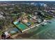 Stunning aerial view of a luxurious estate with pools, sport courts, and waterfront access at 800 Druid S Rd, Clearwater, FL 33756