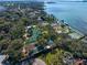 Captivating aerial shot showcasing a sprawling waterfront estate with lush landscaping and scenic bay views at 800 Druid S Rd, Clearwater, FL 33756
