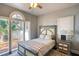 Cozy bedroom with a decorative rug, a ceiling fan and a window offering natural light at 800 Druid S Rd, Clearwater, FL 33756
