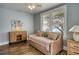 Comfortable bedroom with hardwood floors, a ceiling fan, and a sunny window view at 800 Druid S Rd, Clearwater, FL 33756