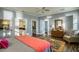Bedroom with decorative area rug, hardwood floors, ensuite access to the bathroom, and sunny window at 800 Druid S Rd, Clearwater, FL 33756