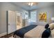 Nicely appointed bedroom offering a queen bed, natural light, and charming wall art at 800 Druid S Rd, Clearwater, FL 33756