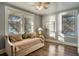 Sunlit bedroom with beautiful hardwood floors, fan, and a sunny window view at 800 Druid S Rd, Clearwater, FL 33756