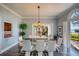 Spacious dining room with a glass table, modern chairs, and an open layout with views of the outdoor landscape at 800 Druid S Rd, Clearwater, FL 33756