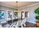 Elegant dining room with a sleek glass table, contemporary chairs, and stylish lighting at 800 Druid S Rd, Clearwater, FL 33756