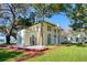 Elegant home with large windows, lush landscaping, and a brick walkway leading to the entrance at 800 Druid S Rd, Clearwater, FL 33756