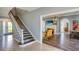 Bright foyer with a staircase and an open view to the living room featuring a fireplace and water views at 800 Druid S Rd, Clearwater, FL 33756