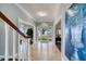 Inviting foyer with tile flooring and a staircase, showcasing a glimpse of the water view through the front doors at 800 Druid S Rd, Clearwater, FL 33756