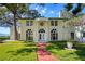 Stately two-story home featuring a manicured lawn, brick walkway, and classic architectural details at 800 Druid S Rd, Clearwater, FL 33756