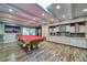 Spacious game room with a pool table, built-in shelving, and ample lighting at 800 Druid S Rd, Clearwater, FL 33756
