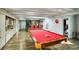 Spacious game room featuring a pool table, bar with Coca Cola decor, and custom built-in storage cabinets at 800 Druid S Rd, Clearwater, FL 33756