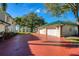 Spacious three-car garage with a brick driveway, set against the backdrop of a charming home at 800 Druid S Rd, Clearwater, FL 33756