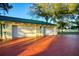 Three-car garage with a charming brick driveway and well-maintained landscaping at 800 Druid S Rd, Clearwater, FL 33756