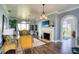 Comfortable living room with a fireplace, pendant lighting, and large windows offering scenic views at 800 Druid S Rd, Clearwater, FL 33756