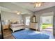 Bright and airy main bedroom featuring a large bed, en-suite, and French doors to a courtyard at 800 Druid S Rd, Clearwater, FL 33756