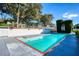 Private backyard pool with elegant white fencing and beautifully landscaped surroundings at 800 Druid S Rd, Clearwater, FL 33756