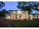 Beautiful exterior with a manicured lawn, patio area and large trees offering shade at 800 Druid S Rd, Clearwater, FL 33756