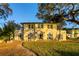 Expansive backyard with lush green lawn, patio area, and manicured landscape at 800 Druid S Rd, Clearwater, FL 33756