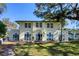 Inviting backyard featuring a patio, lush lawn, and an elegant home exterior at 800 Druid S Rd, Clearwater, FL 33756