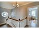 Upstairs landing with wooden floors and decorative trim, leading to a sunlit bedroom at 800 Druid S Rd, Clearwater, FL 33756