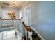 Light-filled stairwell with hardwood stairs, white banisters and modern art at 800 Druid S Rd, Clearwater, FL 33756