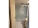 Bathroom features a glass door shower, white tile flooring, and a toilet with white cabinetry at 8100 Dr Martin Luther King Jr N St # 302, St Petersburg, FL 33702
