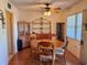 Inviting dining room features a round table with four chairs, a ceiling fan, and wood-look laminate flooring at 8100 Dr Martin Luther King Jr N St # 302, St Petersburg, FL 33702