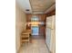 Functional kitchen with wood cabinets, white appliances, and a small table with chairs at 8100 Dr Martin Luther King Jr N St # 302, St Petersburg, FL 33702