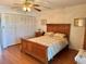 Bedroom features a wood-look laminate floor and a coordinated bedroom set, with a large bed and a closet at 8100 Dr Martin Luther King Jr N St # 302, St Petersburg, FL 33702